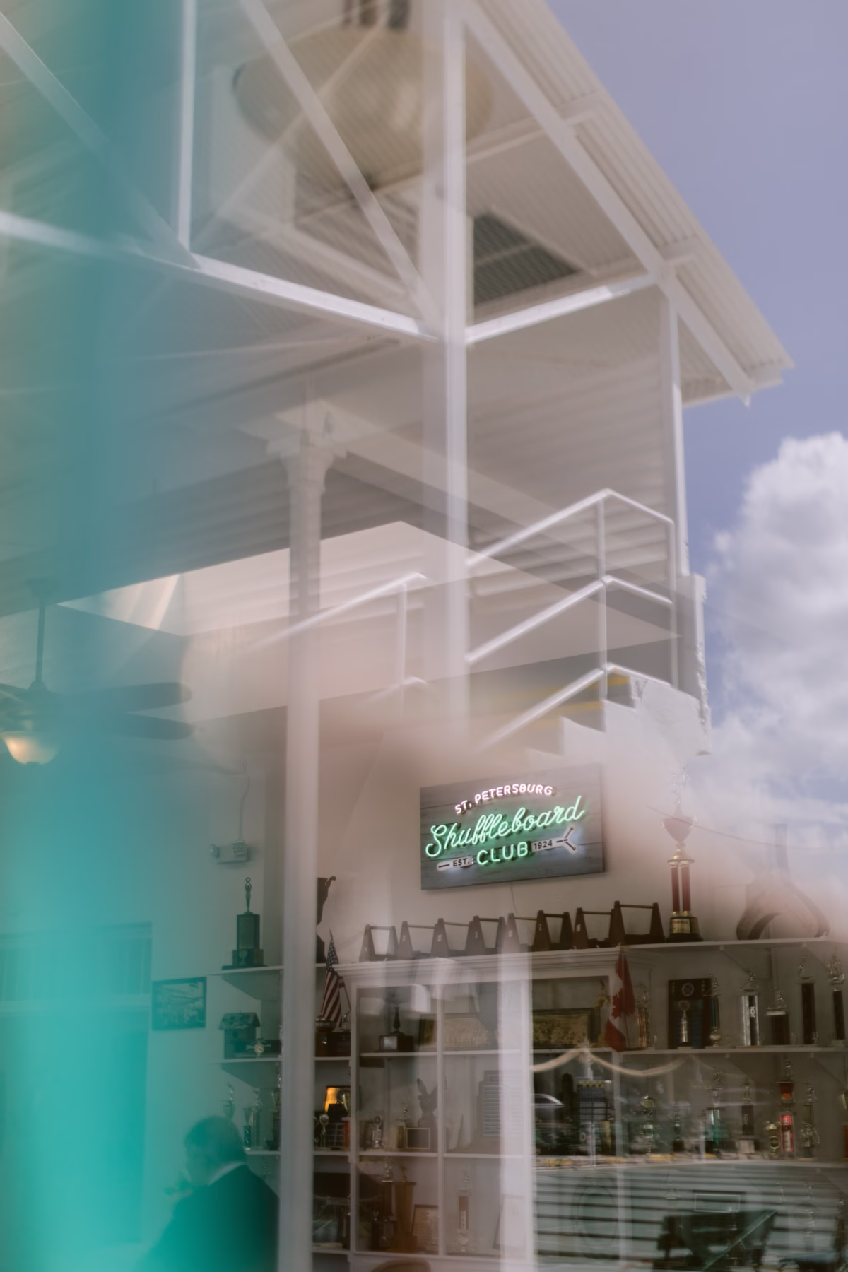 St Pete Shuffleboard Club wedding venue interior showing white architectural beams and vintage signage captured by Tampa Bay wedding photographer Ashley Izquierdo Photography