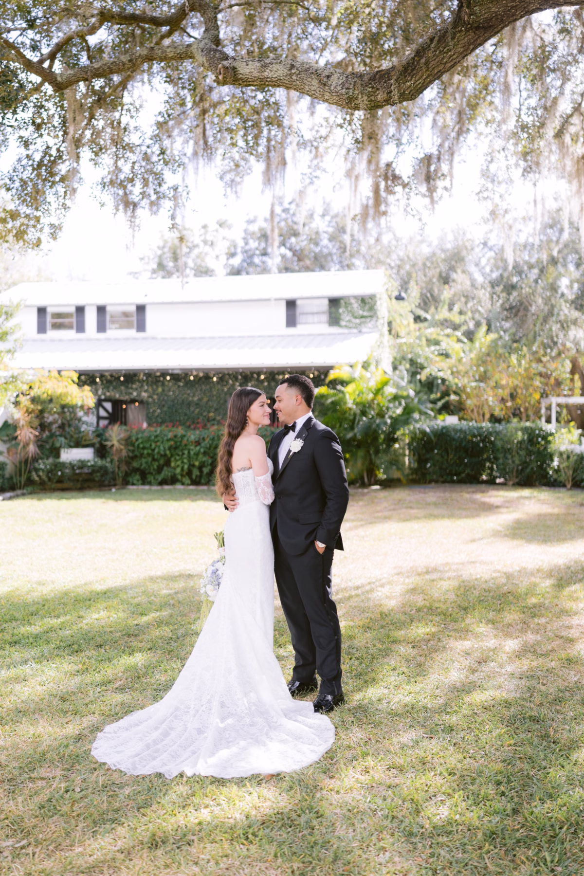 Bride and groom romantic portrait under oak tree at Soire Estate Tampa wedding photographed by Ashley Izquierdo Photography