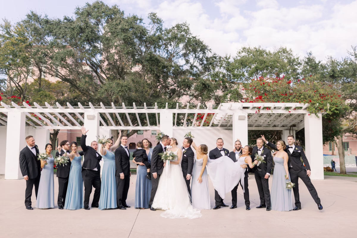 Wedding party celebrates with cheers at The Vinoy St. Petersburg waterfront venue with planning by Lemon Drops Weddings and Events
