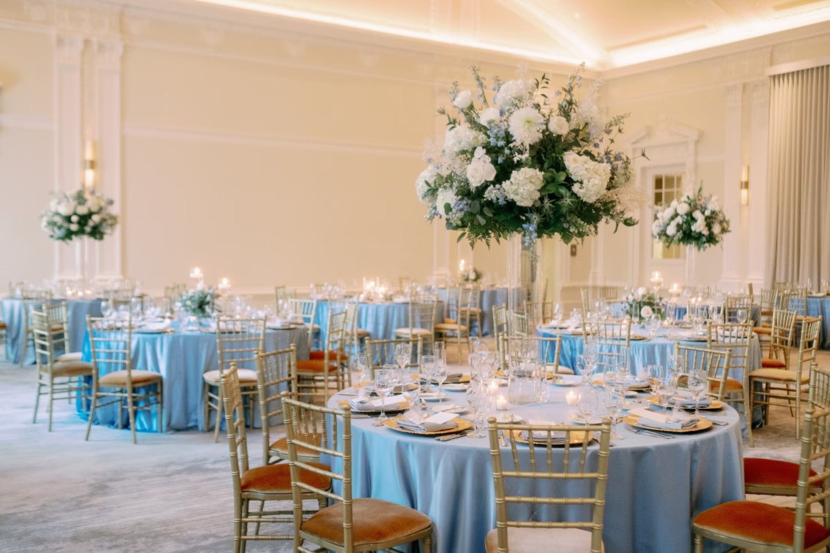 Elegant wedding reception at The Vinoy St. Petersburg with blue linens by Kate Ryan and white floral centerpieces by Lemon Drops Weddings and Events