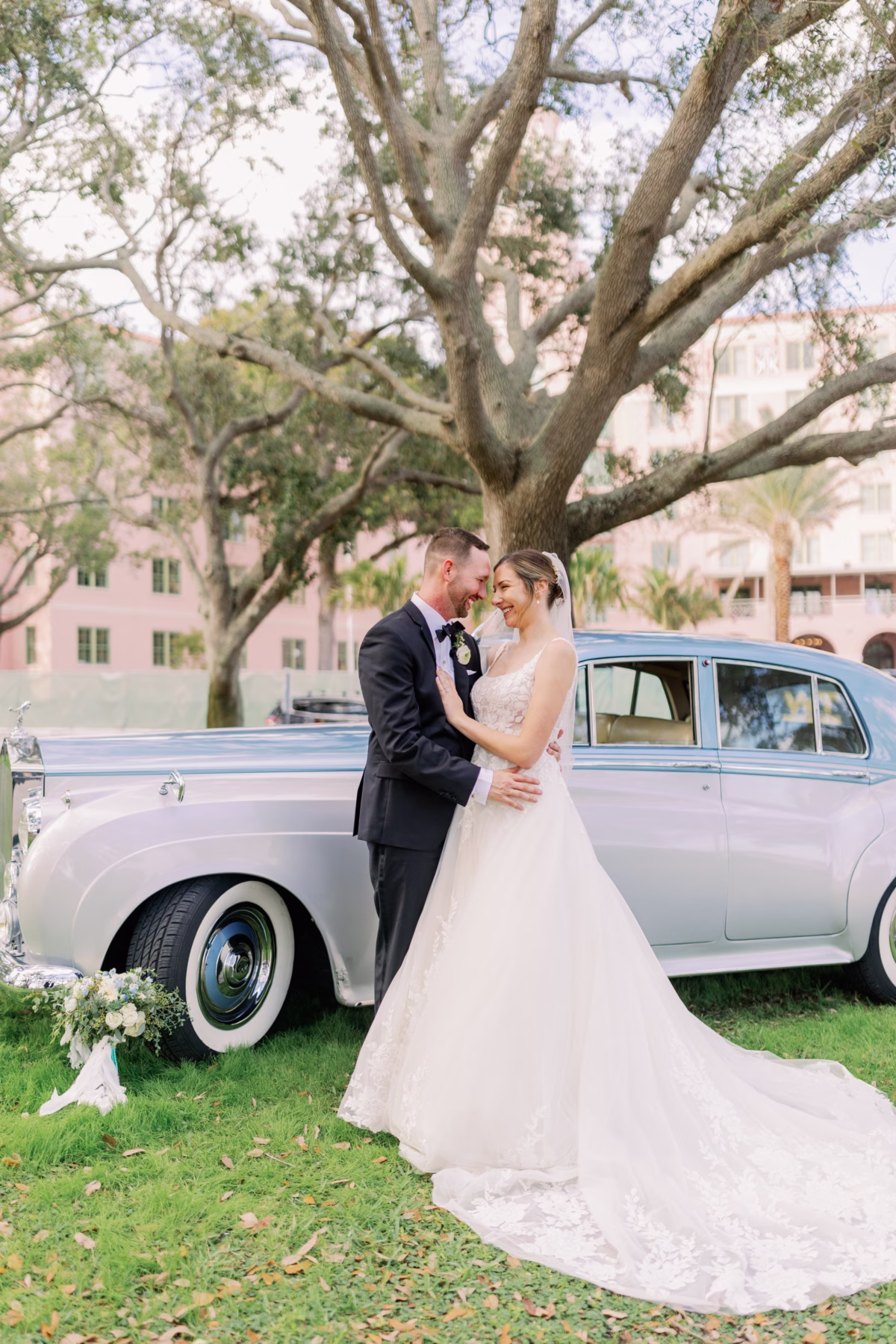 vintage car wedding portraits revvies transportation vinoy st petersburg - Home Bride and groom embracing by vintage car from Revvies Transportation at The Vinoy St. Petersburg waterfront wedding