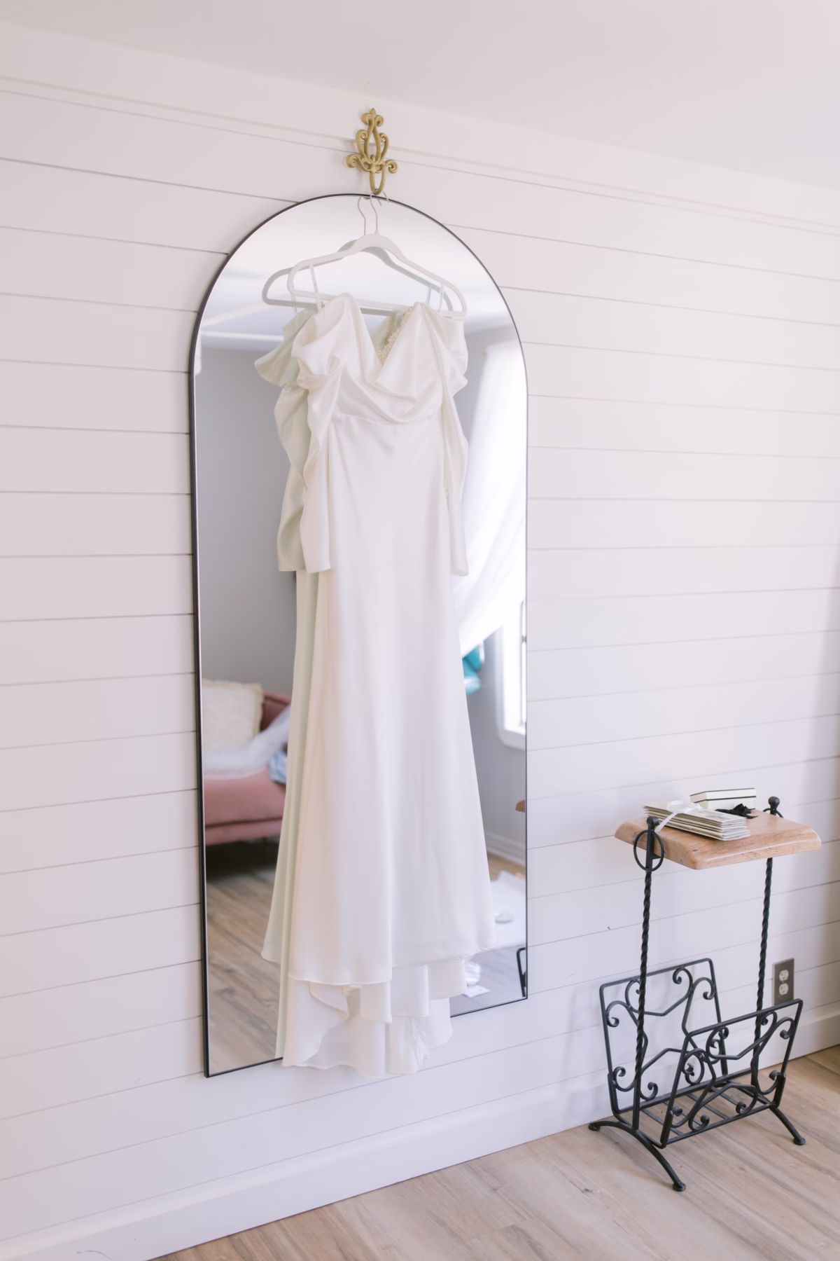 White wedding dress hanging on mirror at Soire Estate Tampa garden wedding by White Traditions Bridal House