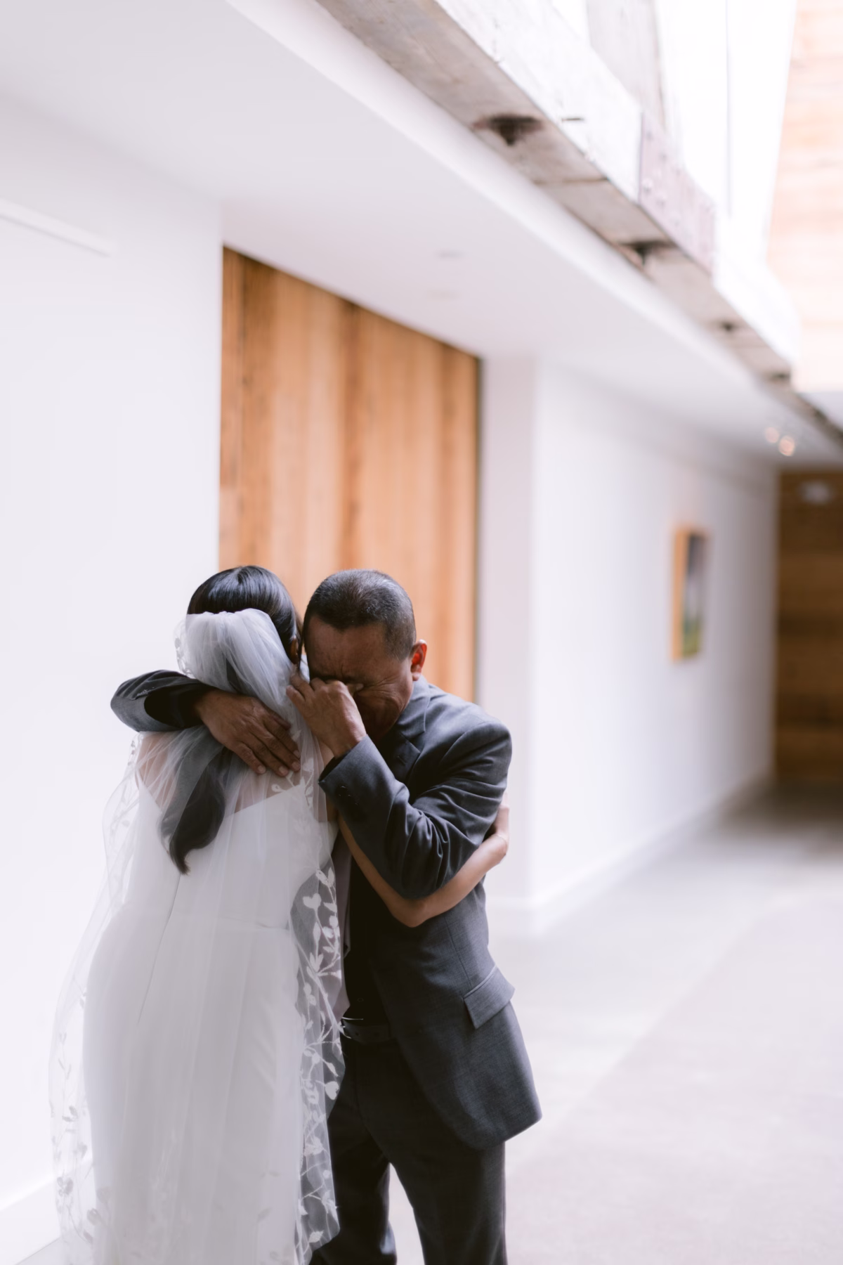 Emotional father-daughter first look moment captured by Ashley Izquierdo Photography at The Roundhouse Beacon wedding venue in Hudson Valley