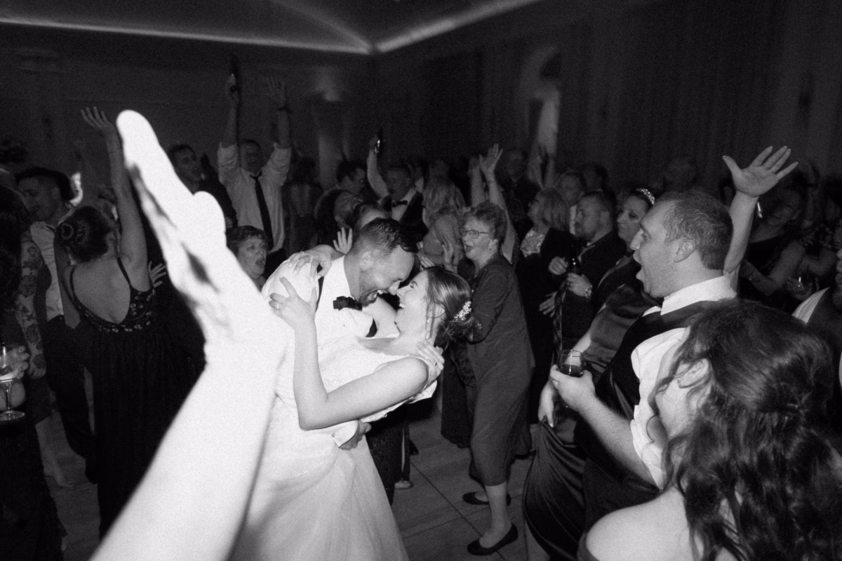 Bride and groom dancing surrounded by celebrating guests with Bay Kings Band entertainment at The Vinoy St. Petersburg waterfront wedding reception