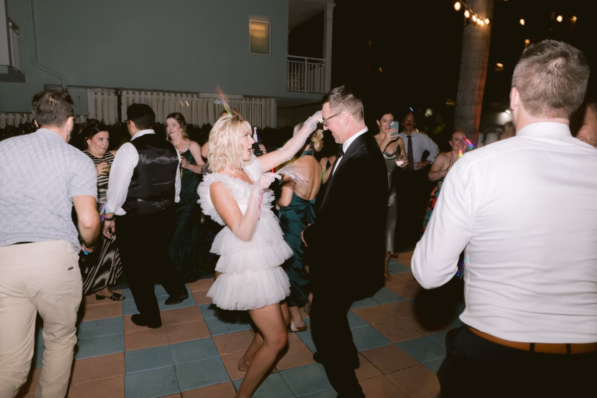 Wedding guests dancing at outdoor reception with DJ Lira at Casa Marina Key West photographed by Ashley Izquierdo Photography