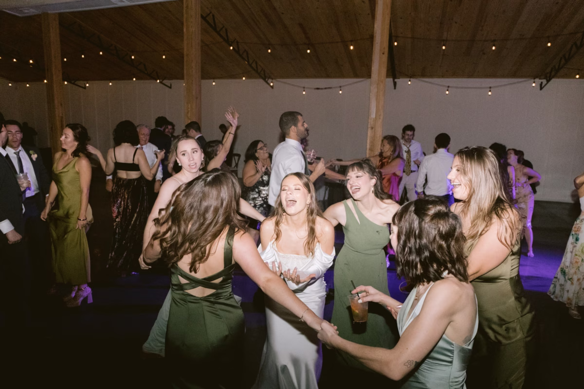 Wedding guests dancing at reception with string lights overhead at Soire Estate Tampa with music by Tampa Bay DJ Co