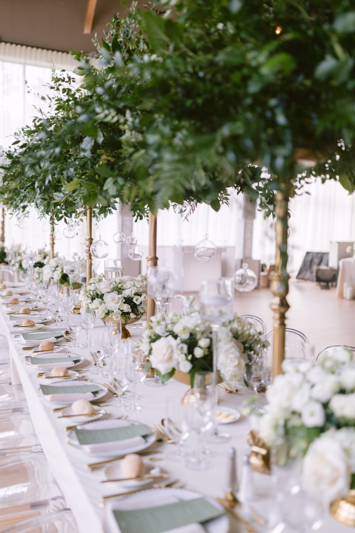 Elegant wedding reception tablescape with tall greenery centerpieces and white floral arrangements by Maky The Diva Flowers at The Roundhouse Beacon Hudson Valley venue