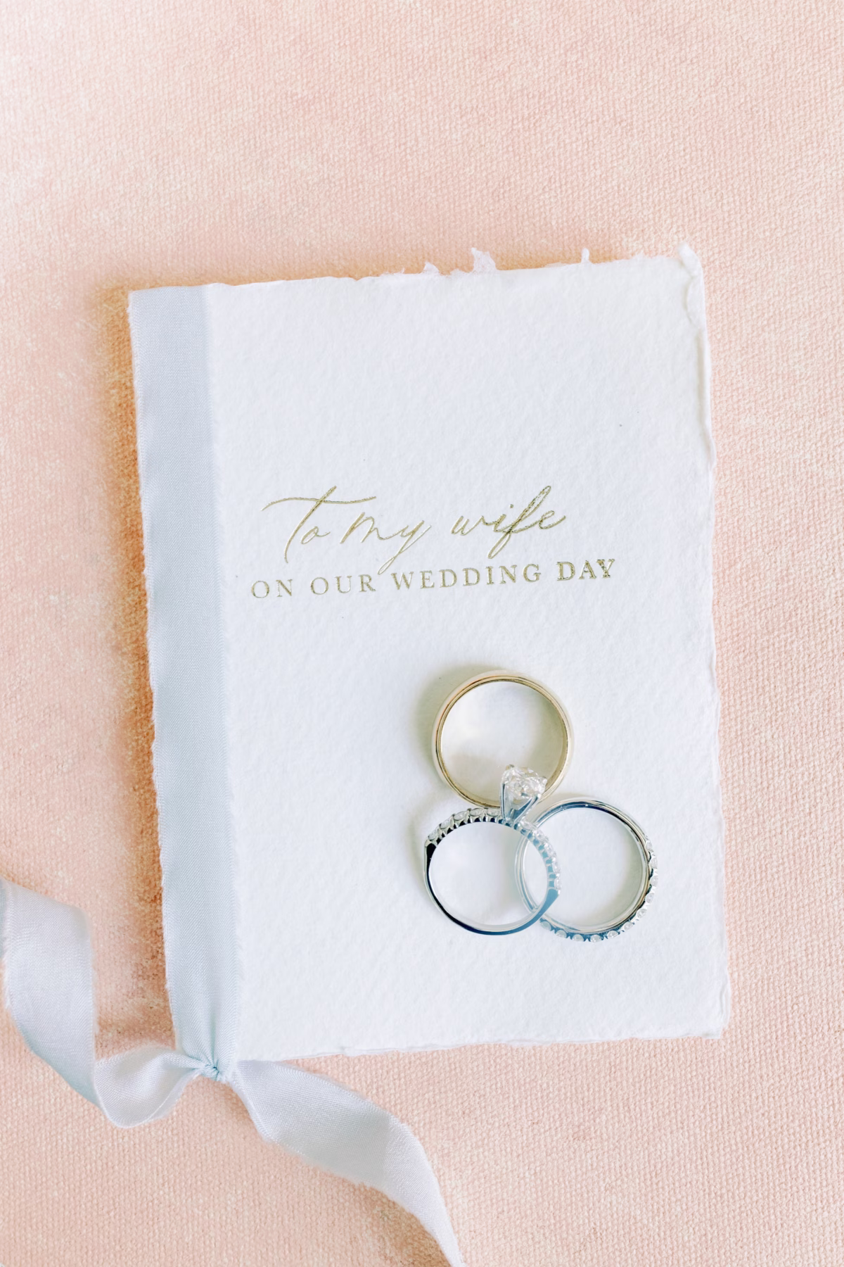 Wedding rings displayed on elegant vows card by Urban Coast stationery at The Vinoy St. Petersburg waterfront wedding