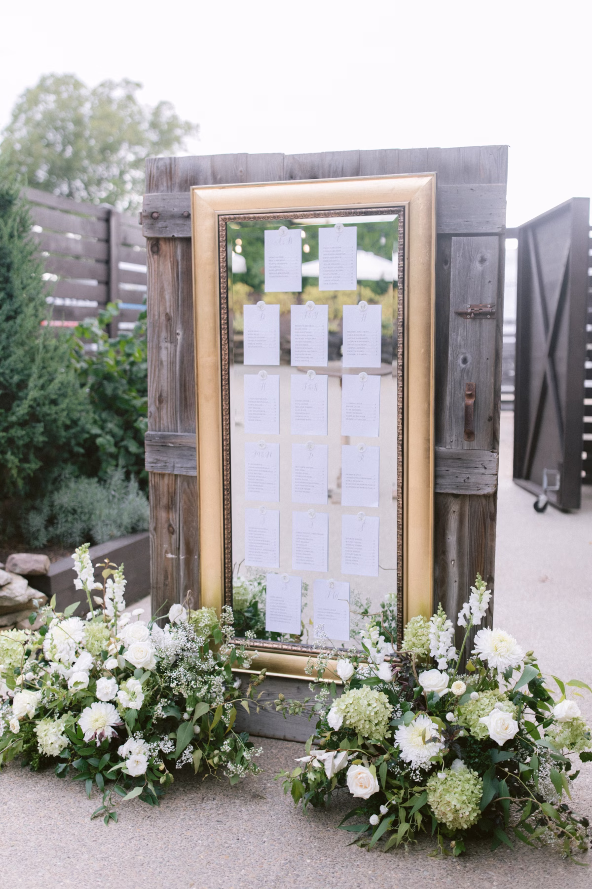 wedding seating chart gold frame florist allie johnson johnsons locust hall - A Farm Wedding at Johnson's Locust Hall, New Jersey Gold framed wedding seating chart with white floral arrangements by Allie Johnson at Johnson's Locust Hall farm wedding in New Jersey