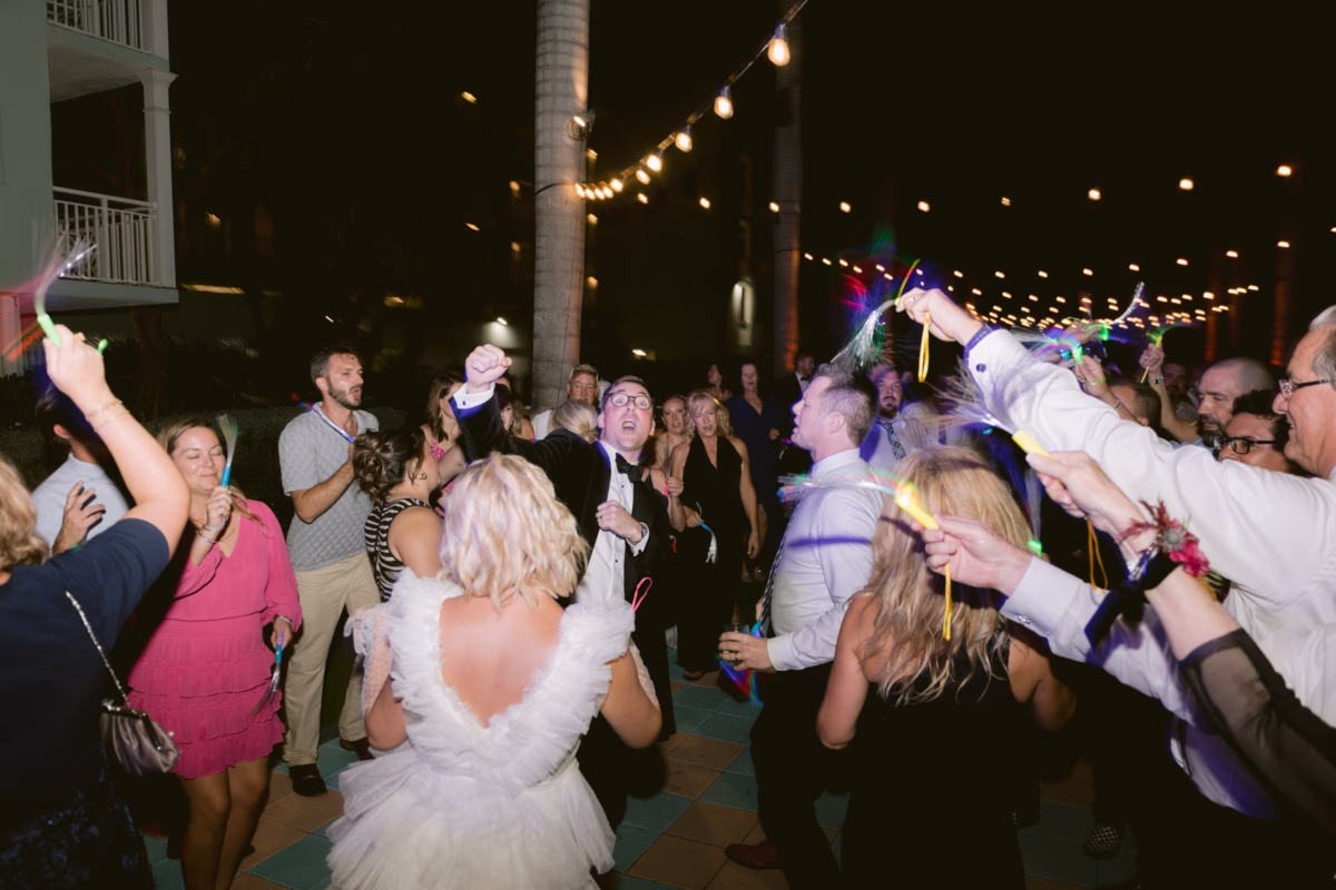 Wedding guests celebrate with sparklers and ribbon wands during sendoff at Casa Marina Key West with DJ Lira entertainment