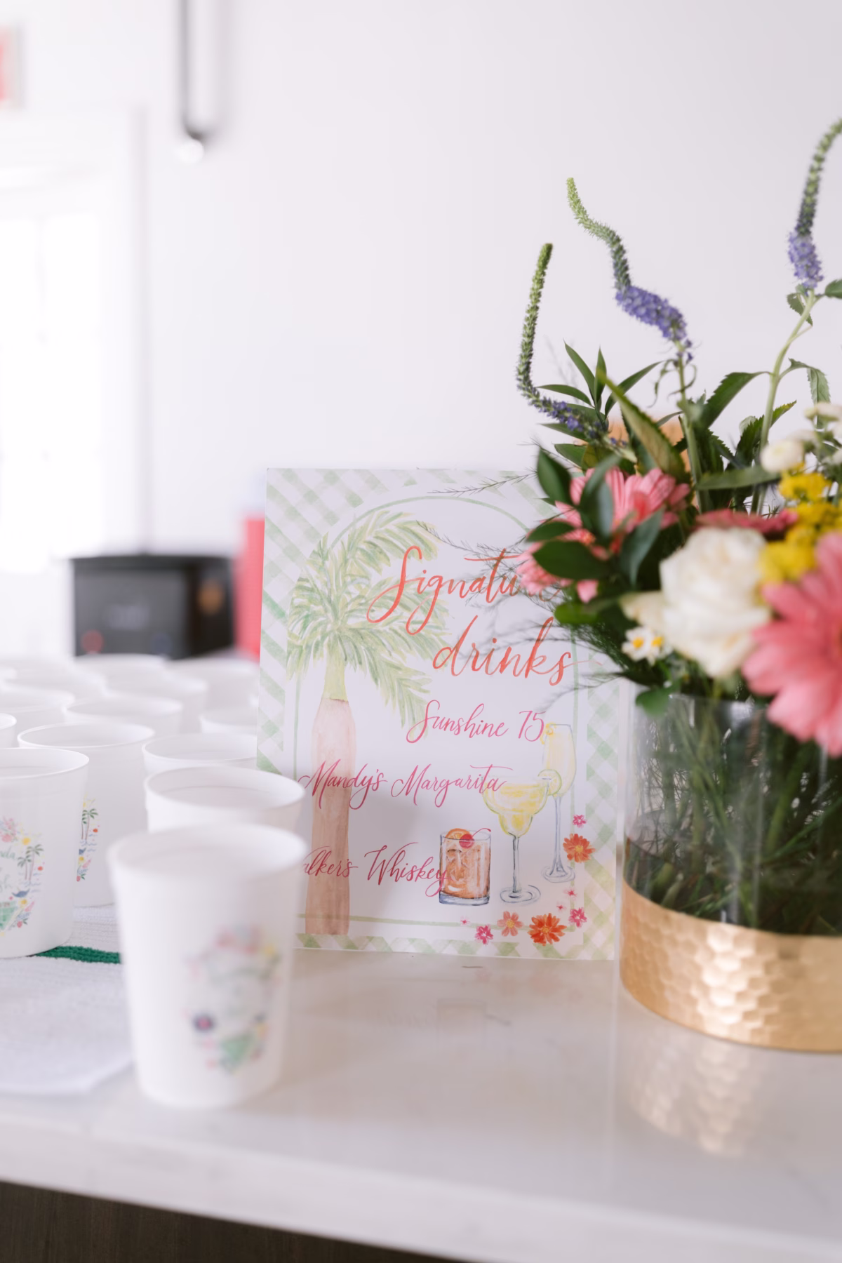 Tropical signature drinks menu by HelenMade Designs with floral arrangement by Petite Fleur at St. Pete Shuffleboard Club wedding