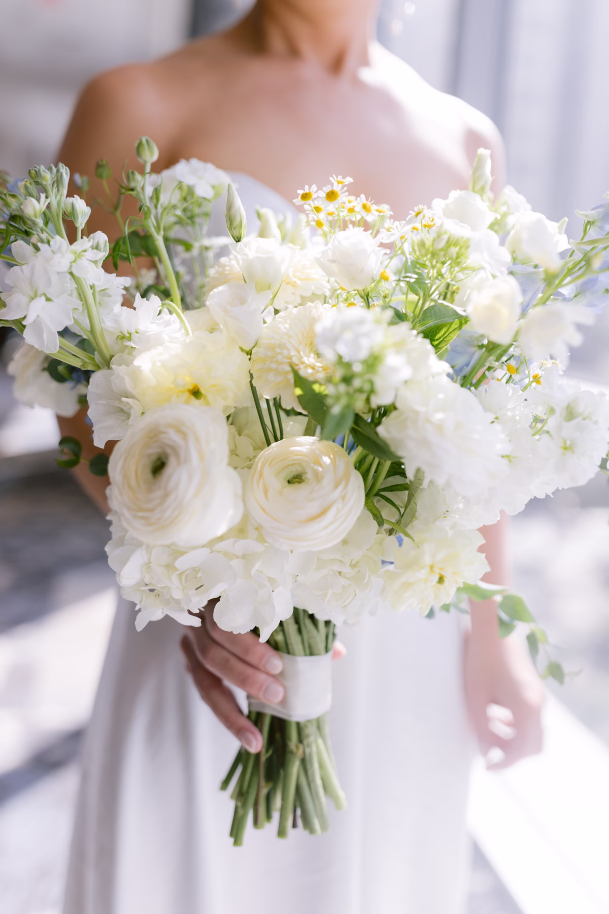 Elegant white wedding bouquet with ranunculus and greenery by Wonderland Floral Art at St. Petersburg art museum wedding