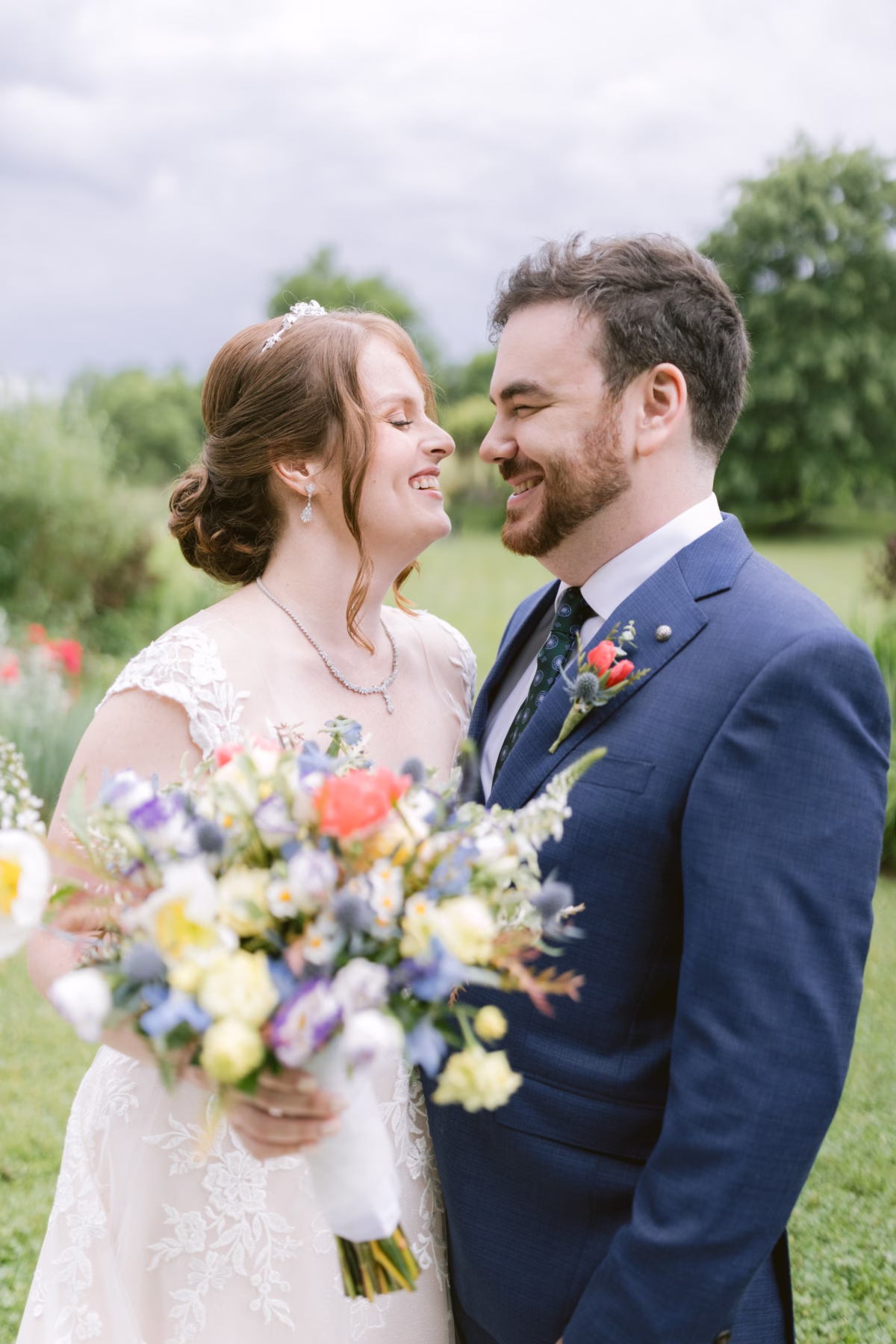 Bride and groom share intimate moment with wildflower bouquet by Cherry Brandy Designs at Red Maple Vineyard wedding captured by Tampa Bay photographer Ashley Izquierdo